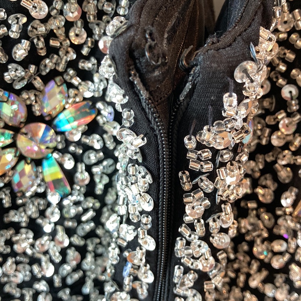Long bejeweled black prom dress with thin straps and slit up to the thigh. - Picture 7 of 12